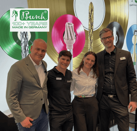 Busch Burs team celebrating 100+ years made in Germany, showcasing innovative dental burs at a 2026 trade show display