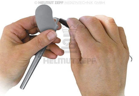 Key for Exchanging Hygiene Instrument Inserts demonstrated by hands in a clinical setting by Helmut Zepf