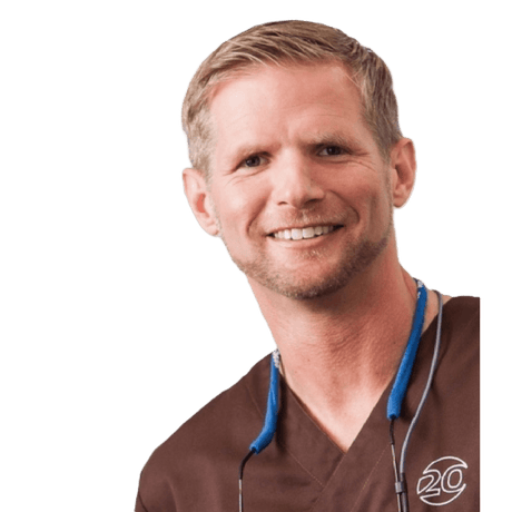 Dr. Kai Zwanzig Instrument collection creator, oral surgery and implantology specialist smiling in scrubs