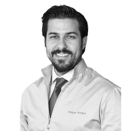 Dr. Bora Korkut Instrument collection creator - professional portrait of Dr. Bora Korkut in dental coat