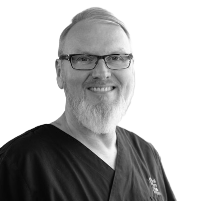 Dr. Detlef Hildebrand Instrument collection creator - leading implantologist portrait in dental scrubs