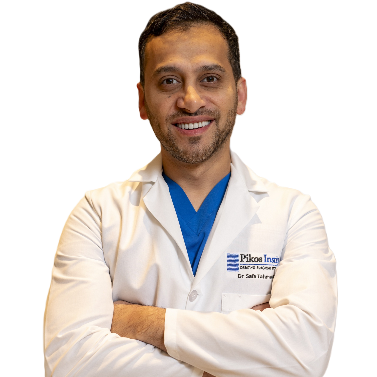 Dr. Safa Tahmasebi prosthodontist in white lab coat at Pikos Institute smiling with arms crossed